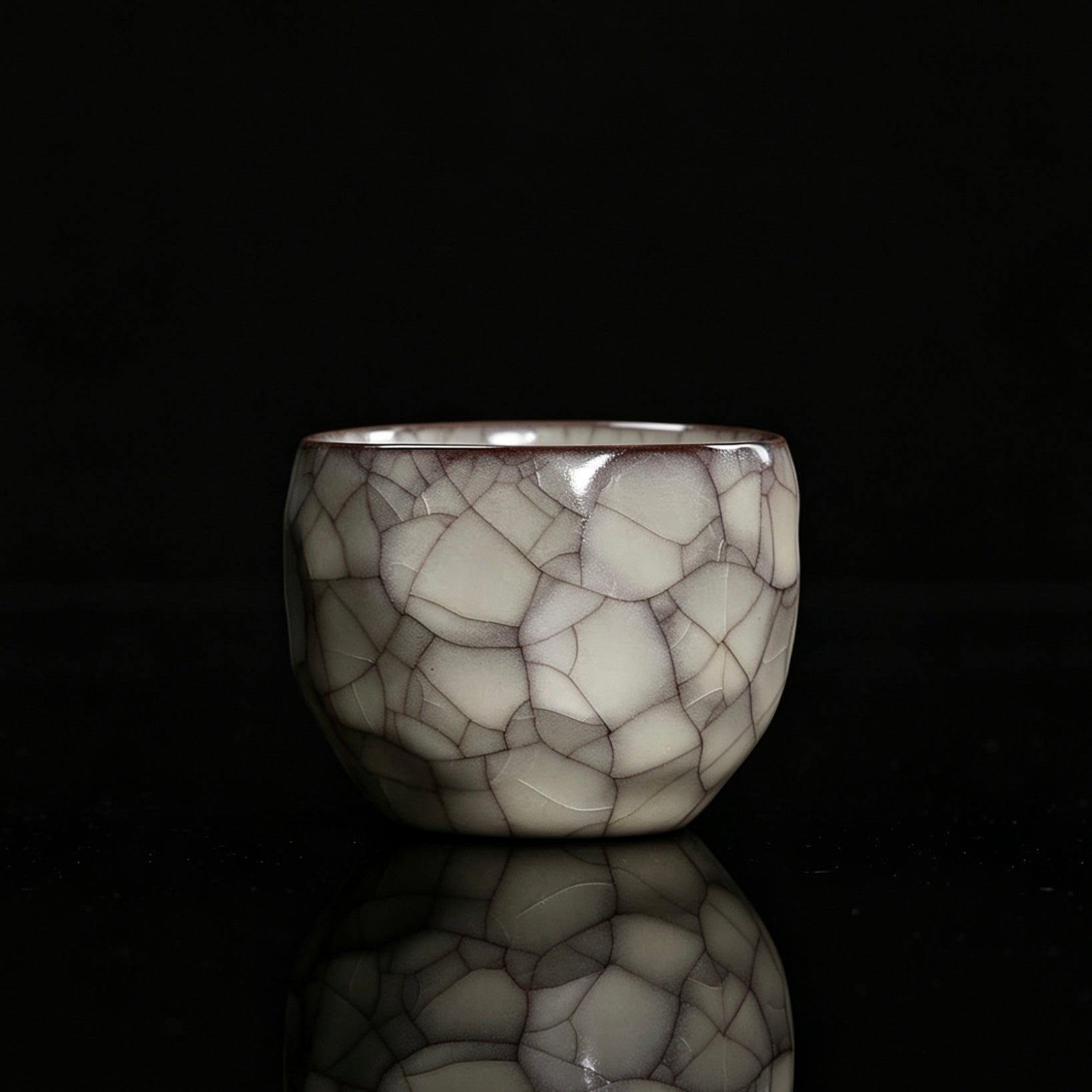 Longquan celadon Ge kiln faceted master cup with irregular geometric planes and oily celadon glaze