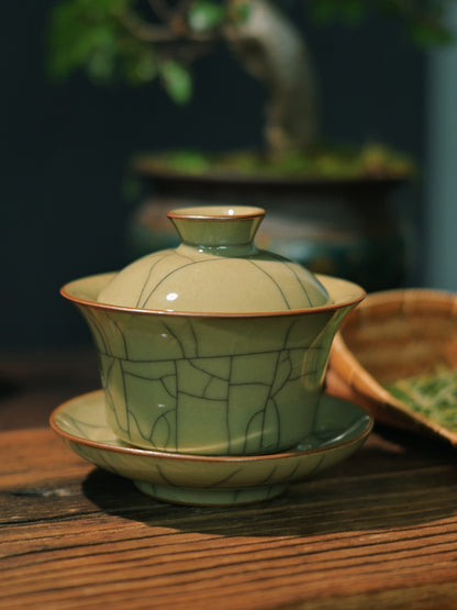 Iron-body 'Sancai' (three talents) gaiwan in Longquan Ge-style celadon featuring distinctive crackle patterns, hand-built for rapid brewing of oolong, pu-erh and white teas.