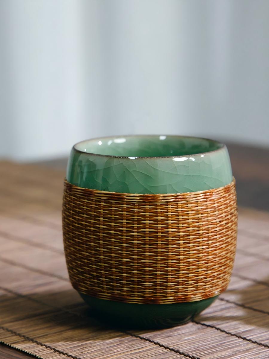 Saanwu Longquan Ge‑Yao celadon teacup with precisely fitted hand‑woven bamboo sleeve over porcelain body