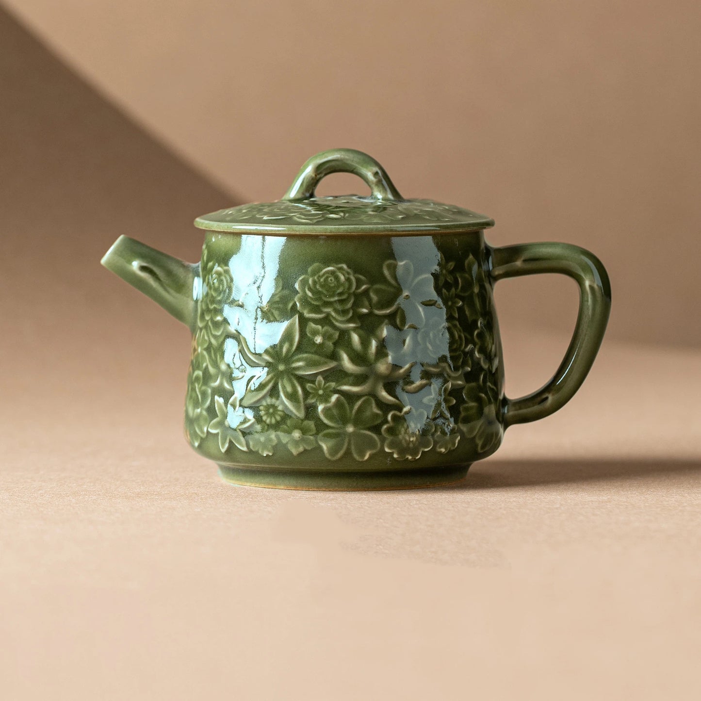 Handcrafted Chinese celadon teapot with floral relief design