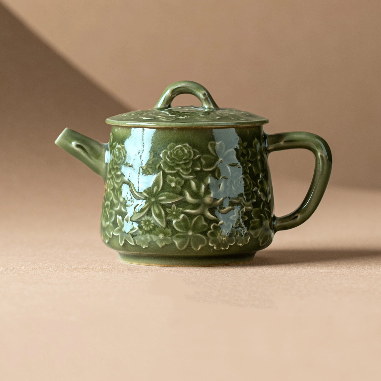 Handcrafted Chinese celadon teapot with floral relief design