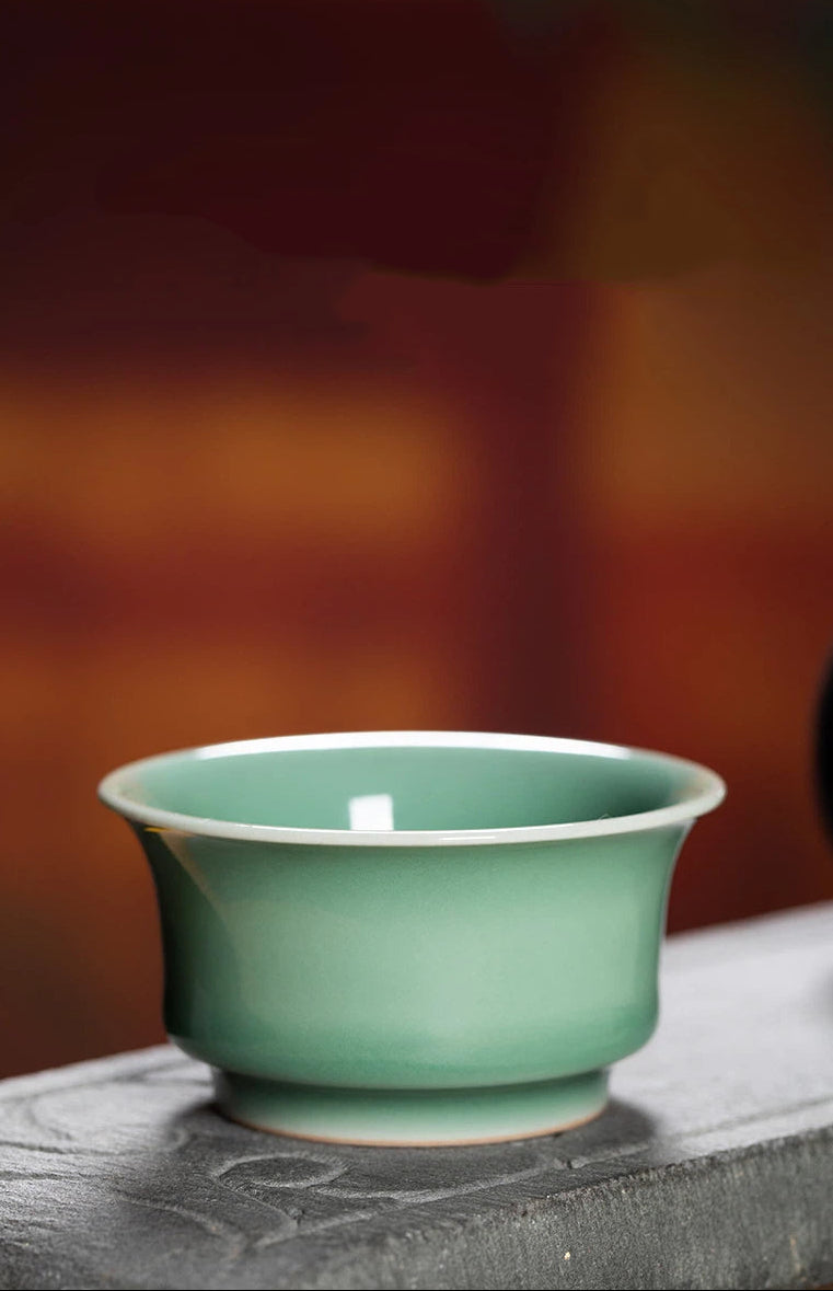 Chinese Longquan Celadon Teacup with Embossed Koi Fish Motif, Combining Artistic Porcelain Carving and Soft Green Glaze for a Peaceful Tea Experience.