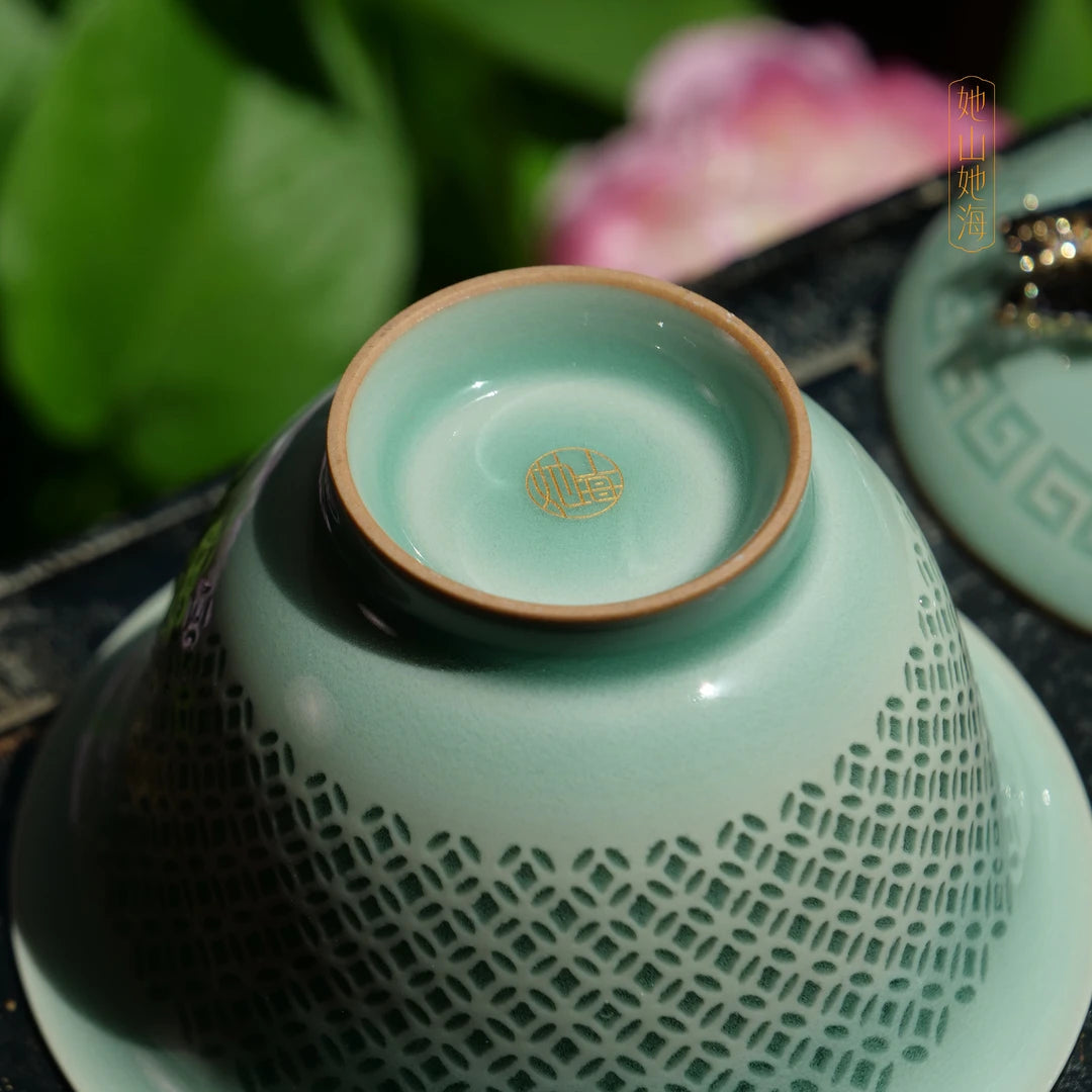 Bottom view showing the neatly trimmed foot ring and artisan base mark of the celadon gaiwan.