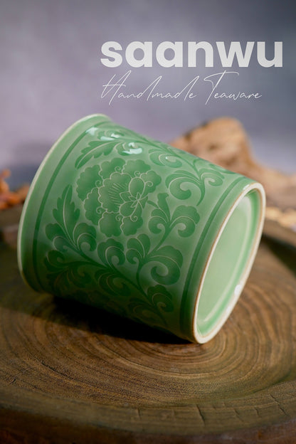 Bottom view showing the neatly finished unglazed foot ring and artisan mark on a handcrafted celadon cup.