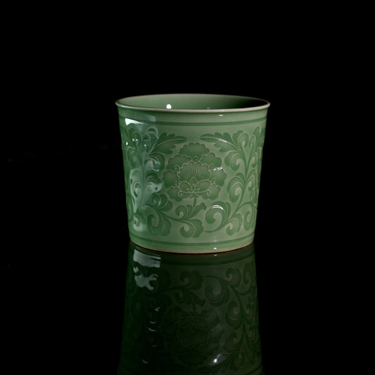 Longquan Celadon Handcrafted Peony Relief Tea Cup and Coffee Cup in a front studio shot.