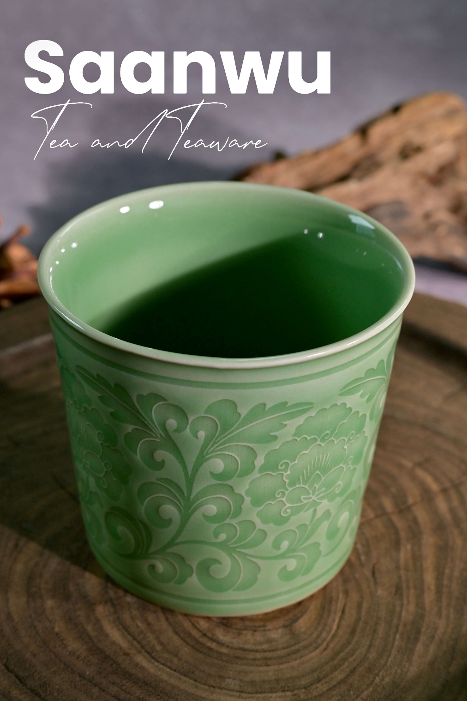 Macro view showing the deep green celadon glaze pooling over the relief peony pattern.
