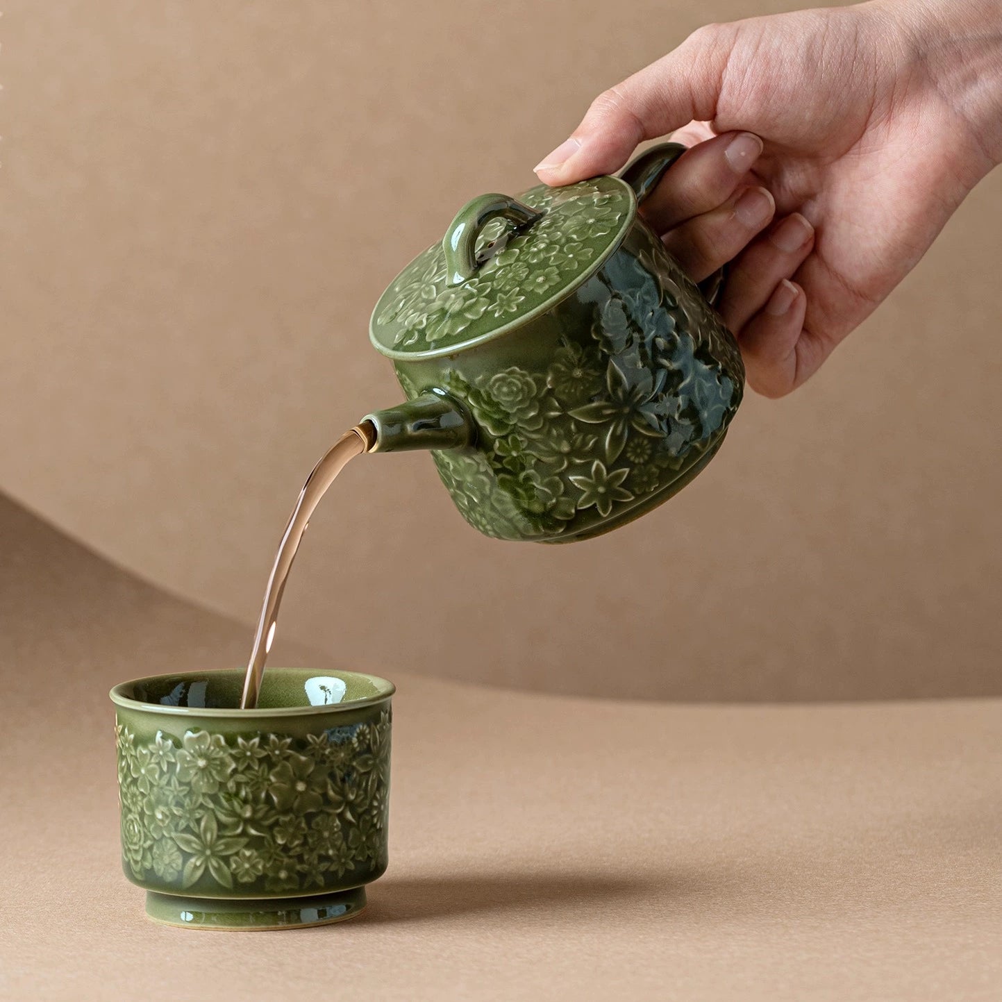 Handmade Longquan celadon teapot with intricate carvings