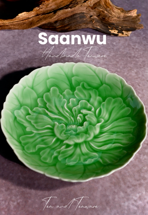 Top-down detail shot focusing on the central peony stamen and carved petal textures of the saucer