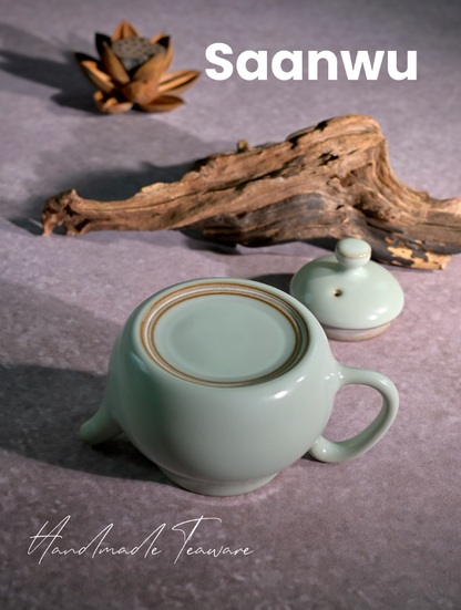 Bottom view showing the unglazed foot ring and artisan mark of the Longquan Celadon pear-shaped teapot.