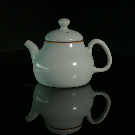 Longquan Celadon Powder Green Glaze Crackle Pear-Shaped Teapot in a front studio shot.