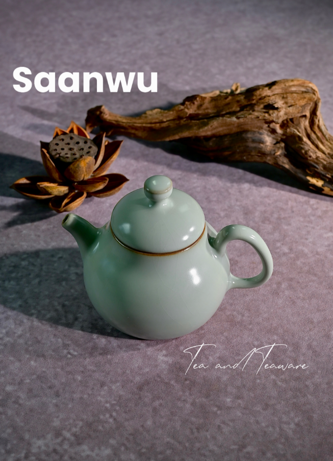 Top-down view showing the finely fitted lid and round button of the powder green celadon teapot.