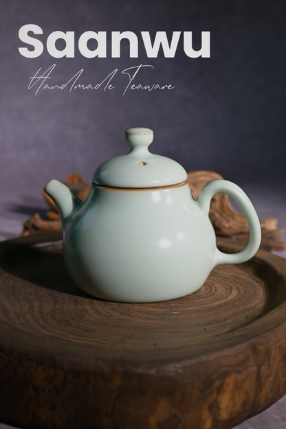 Longquan Celadon Powder Green Glaze Crackle Pear-Shaped Teapot in a front studio shot.