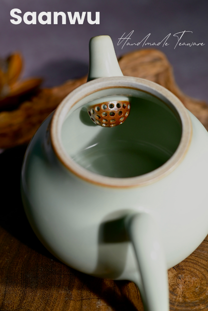 Detail shot of the teapot spout and handle on a handcrafted Longquan Celadon pear-shaped teapot