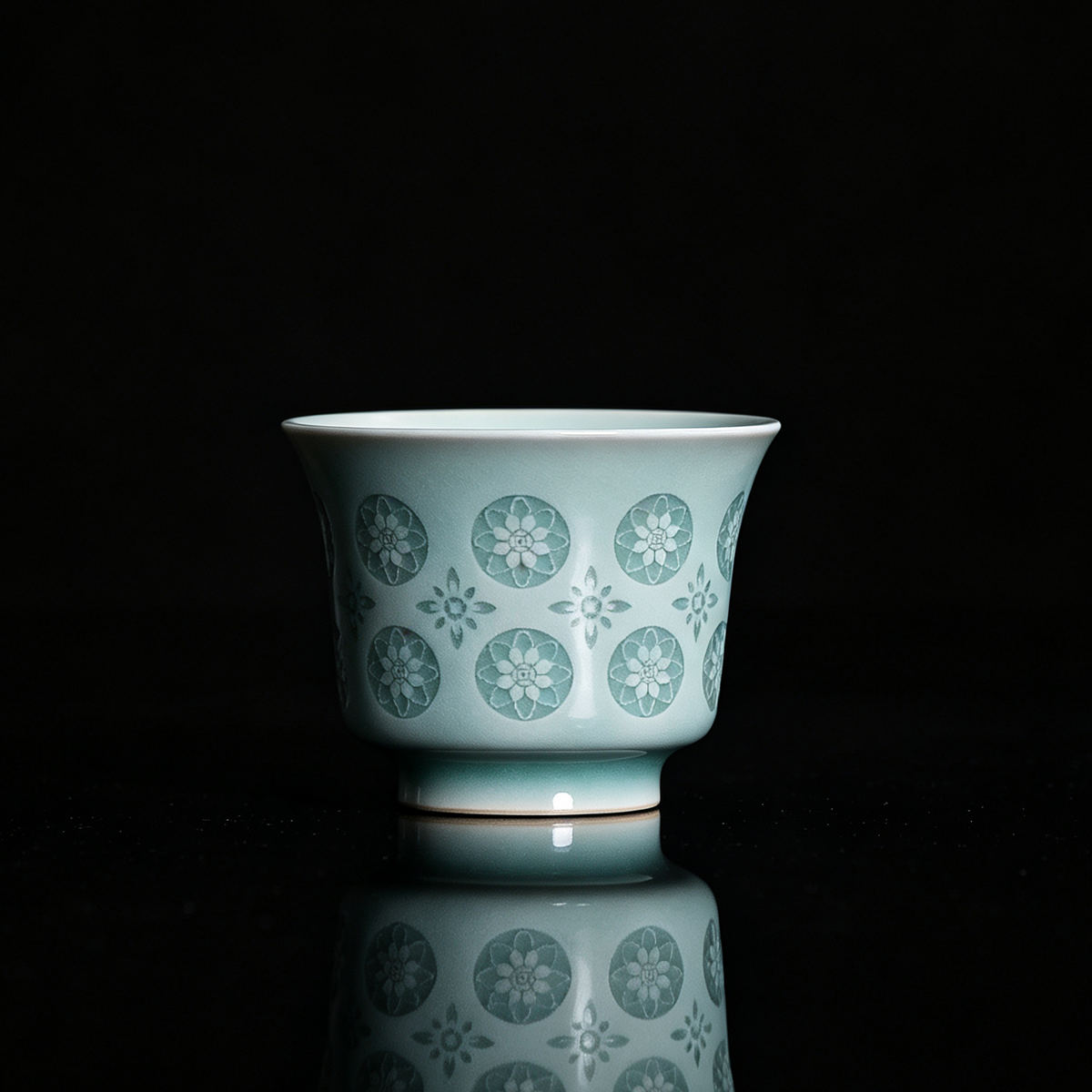 Handcrafted Longquan celadon horse-hoof teacup in powder green glaze with translucent pierced floral Linglong motif