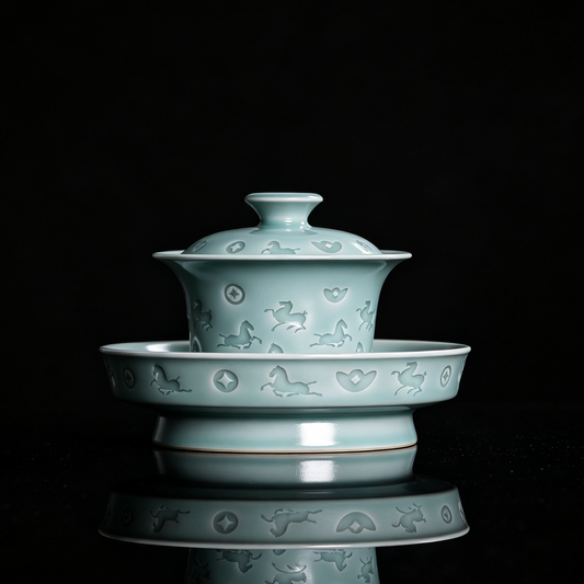 Handcrafted Longquan celadon gaiwan set in powder green glaze with hand-carved galloping horse and wealth coin motifs