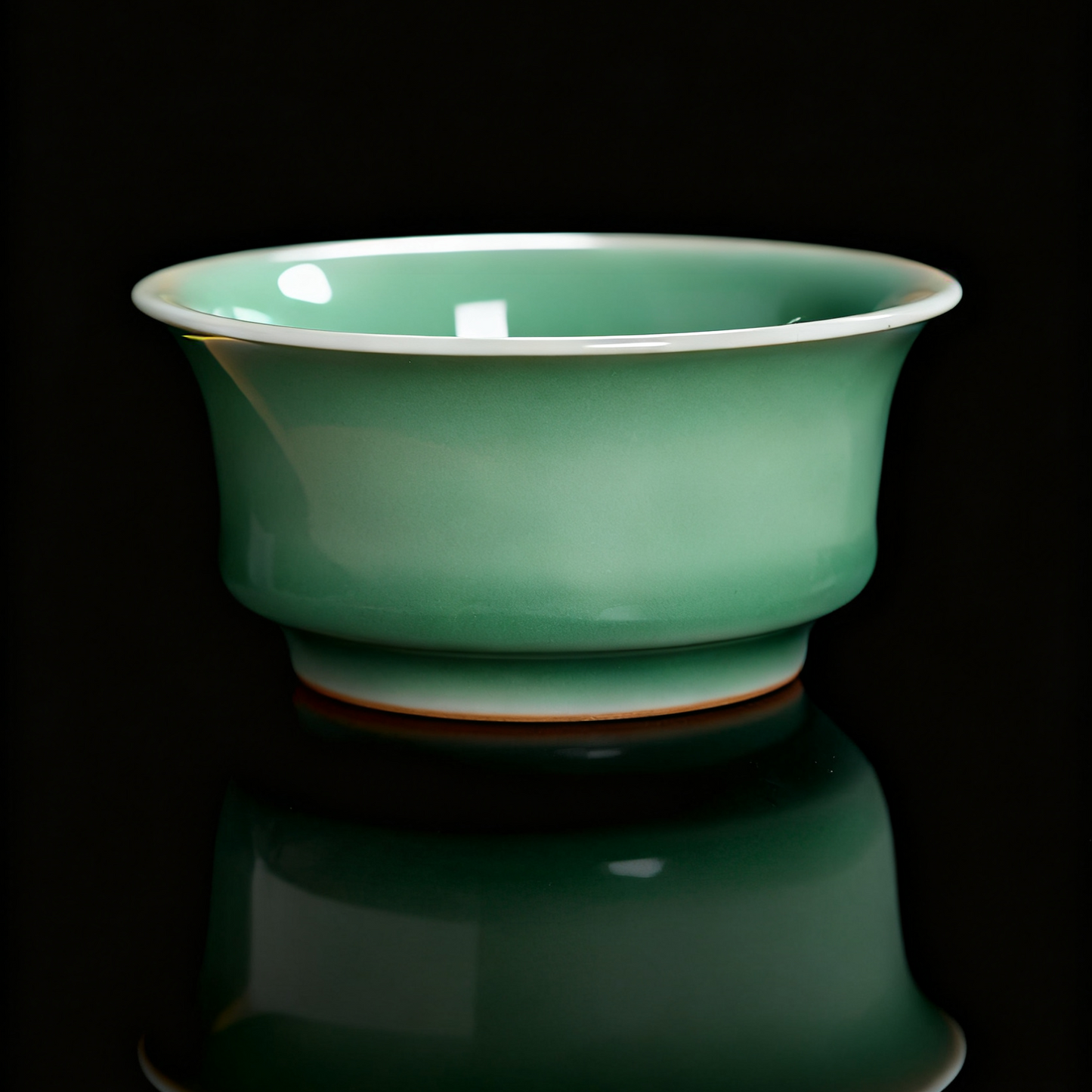 Handmade Longquan Celadon Teacup with Embossed Koi Fish Design, Showcasing Traditional Chinese Porcelain Craftsmanship and Smooth Crackle Glaze.