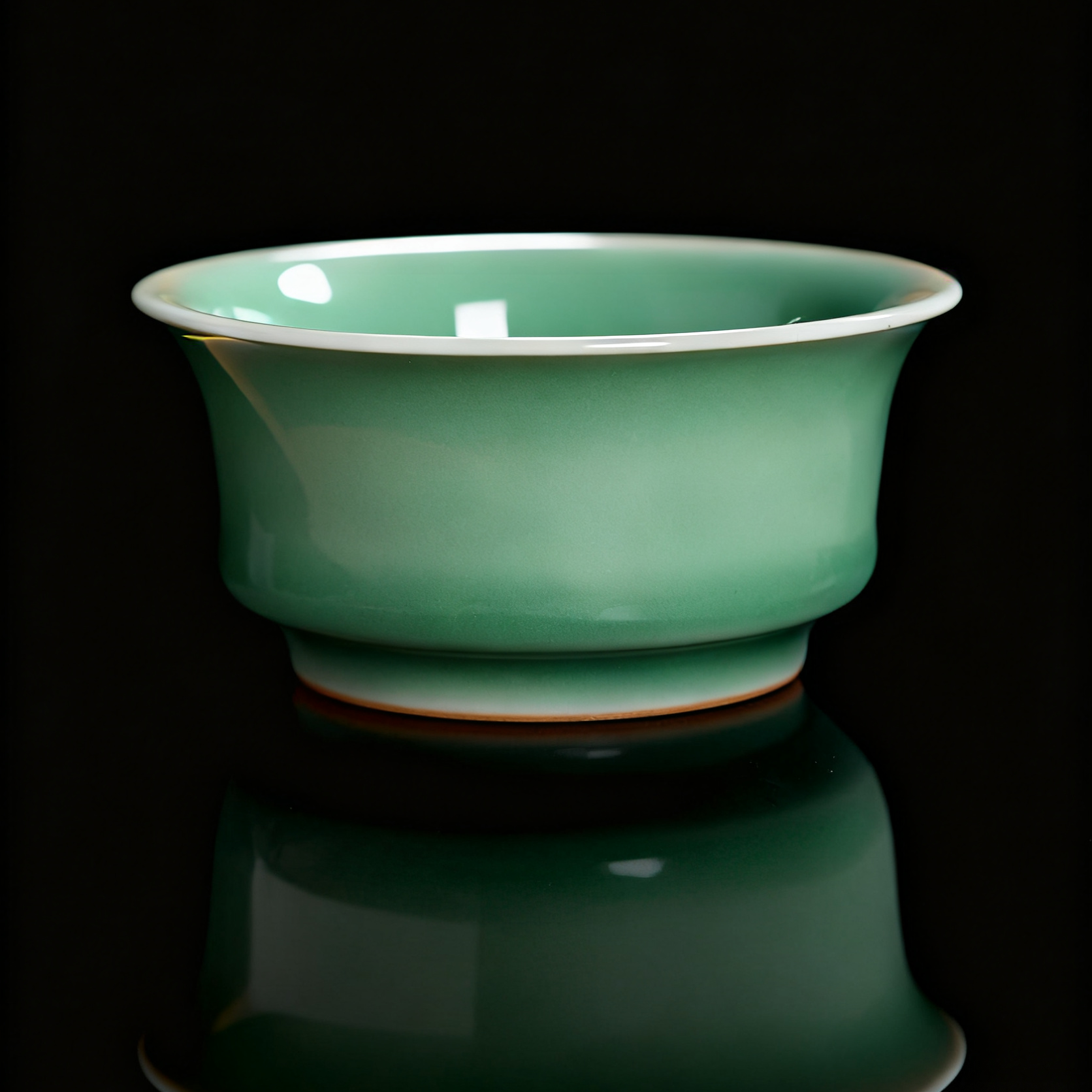 Handmade Longquan Celadon Teacup with Embossed Koi Fish Design, Showcasing Traditional Chinese Porcelain Craftsmanship and Smooth Crackle Glaze.