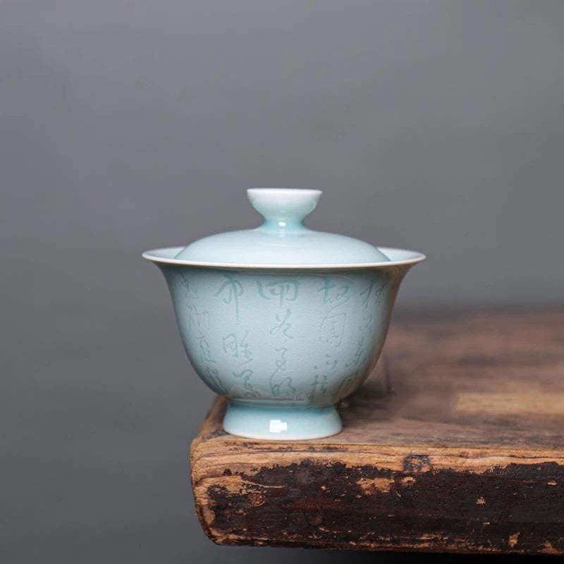 Close-up of the delicate Chinese calligraphy inscribed on the Longquan Celadon porcelain gaiwan.