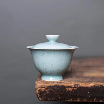 Close-up of the delicate Chinese calligraphy inscribed on the Longquan Celadon porcelain gaiwan.