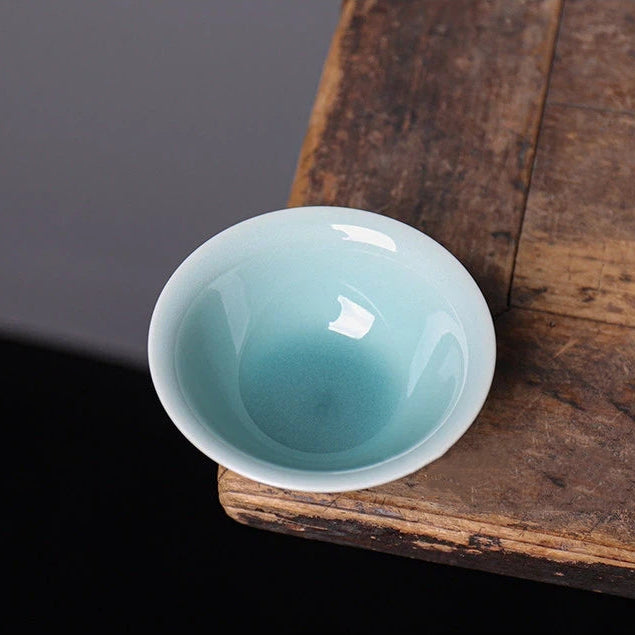 Top-down view of the smooth glazed interior and lotus-shaped rim of the Longquan Celadon cup.