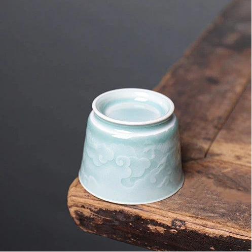 Bottom view showing the unglazed foot ring and authentic craftsmanship of a Longquan Celadon relief carved cup.