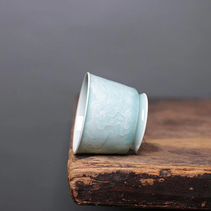 Close-up of the delicate relief carved pattern on a Longquan Celadon tea cup.