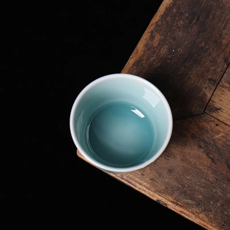 Top-down view highlighting the smooth glazed rim and glossy interior of the Longquan Celadon relief cup.