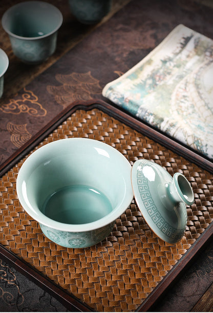 Powder-green Fenqing celadon gaiwan set with glowing translucent flower lattice detail
