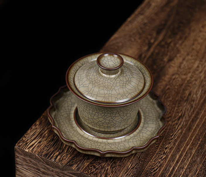 Traditional Longquan celadon GE porcelain three-piece tea bowl set, combining artistry with functional design.
