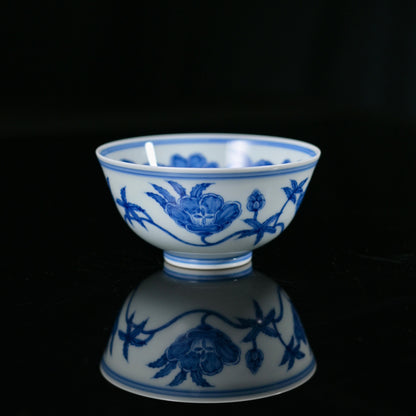 Jingdezhen thin-wall porcelain cup featuring hand-rendered underglaze blue lotus scroll pattern in Ming Dynasty style, showcasing brilliant white glaze and deep cobalt pigmentation.