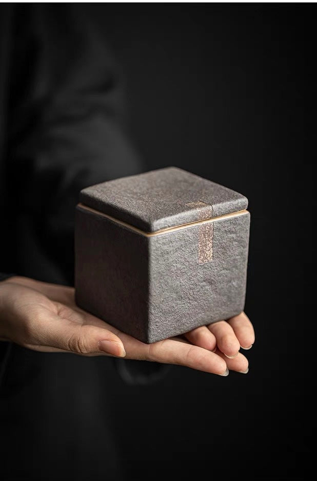 Minimalist unglazed tea container with rough clay texture and wabi-sabi aesthetic
