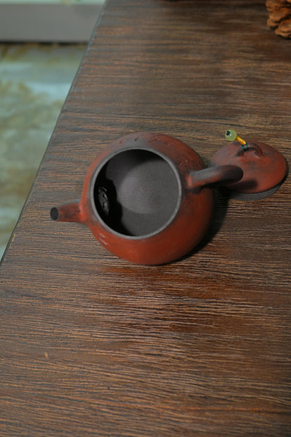 Ergonomic unglazed iron-clay master teapot designed for high-temperature Oolong and Cliff tea steeping