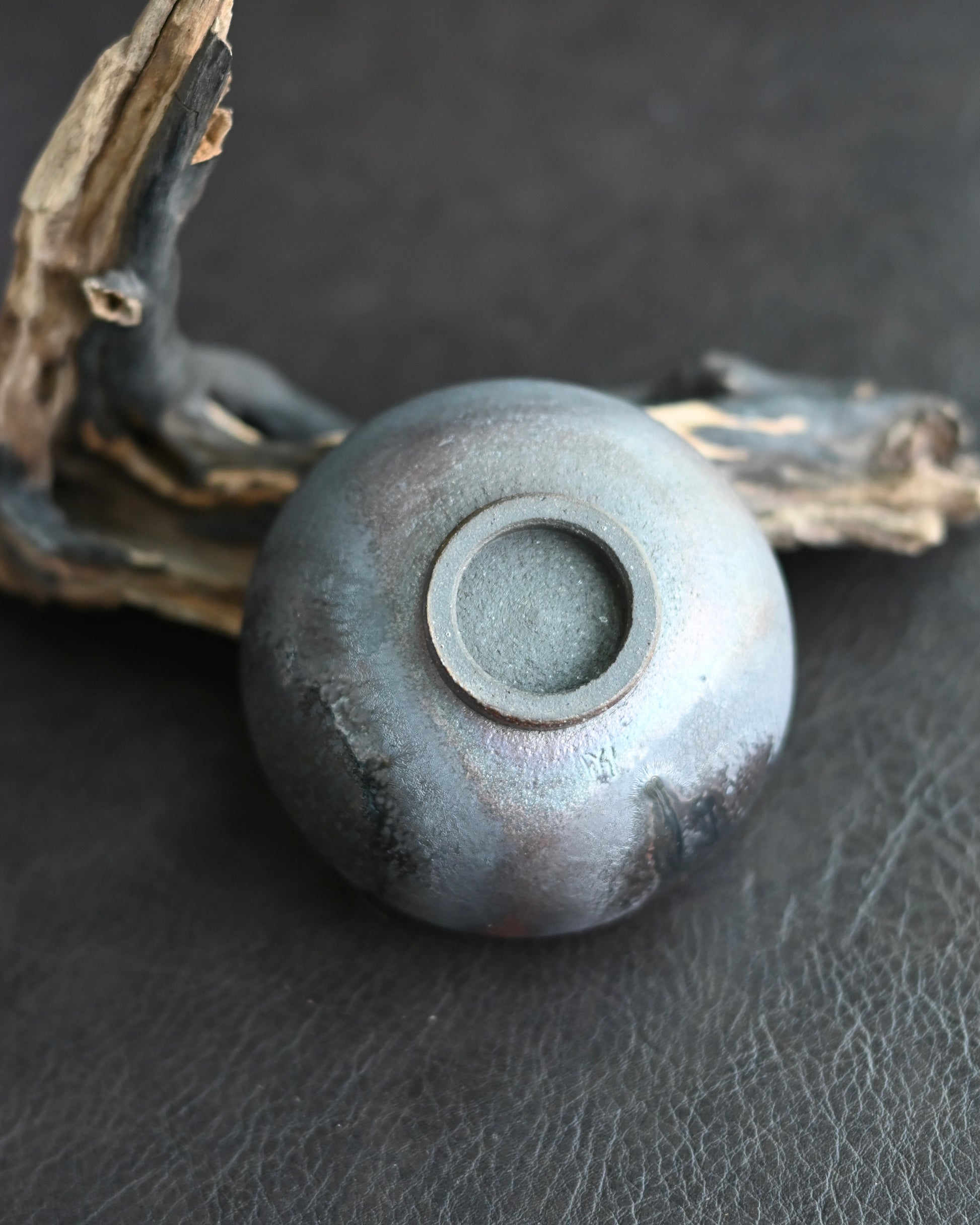 Natural ash glaze crystallization on cup rim from melted pine wood particles