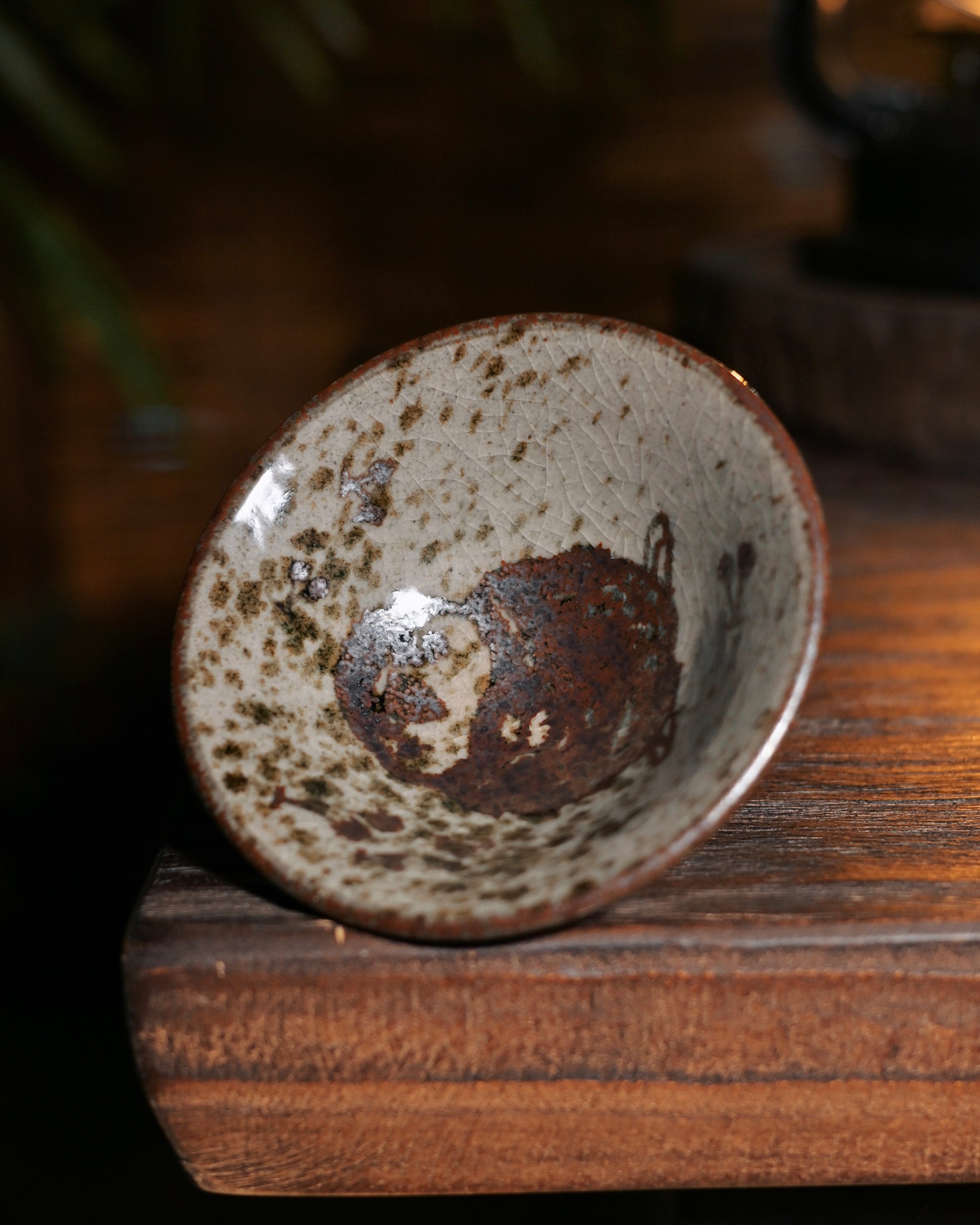Handmade douli cup with rustic glaze formed by natural wood ash, celebrating imperfect beauty in tea ware