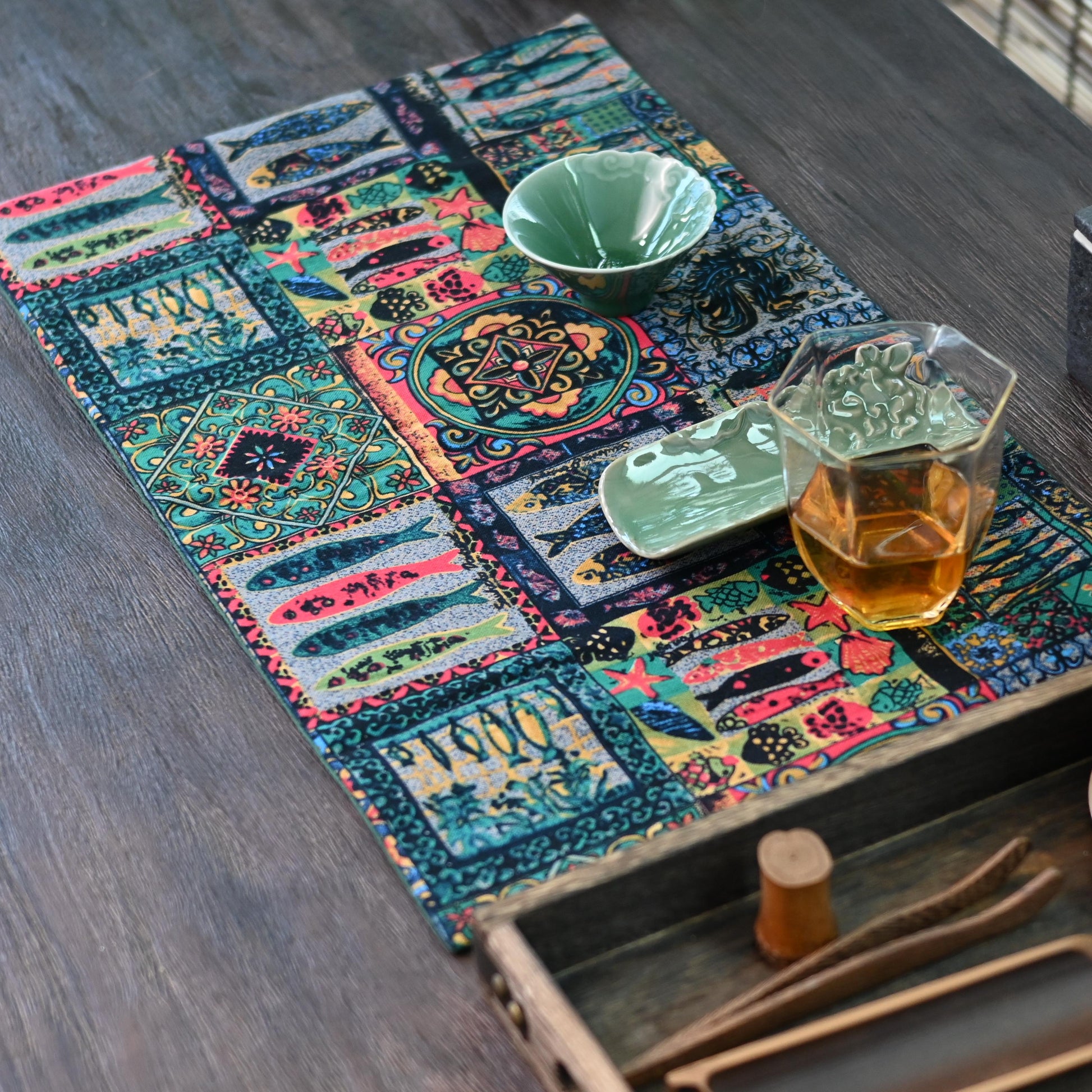 Vintage-inspired fish print tea mat combining decorative appeal with functional absorbency in natural cotton-linen fabric