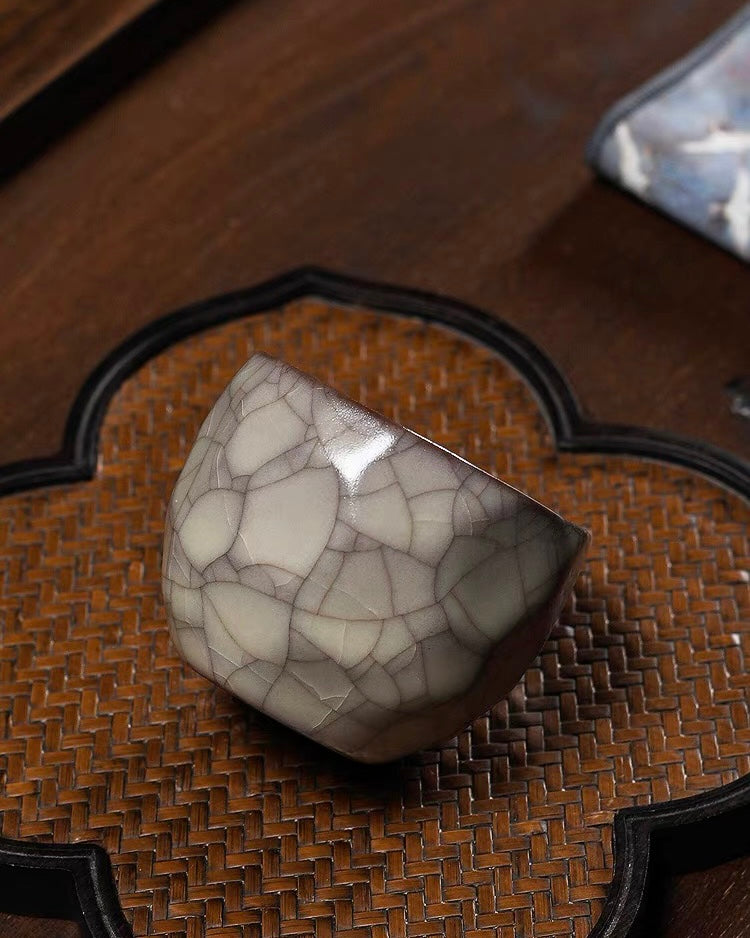 Irregular ceramic cup where flat planes meet at crisp edges creating crystalline appearance
