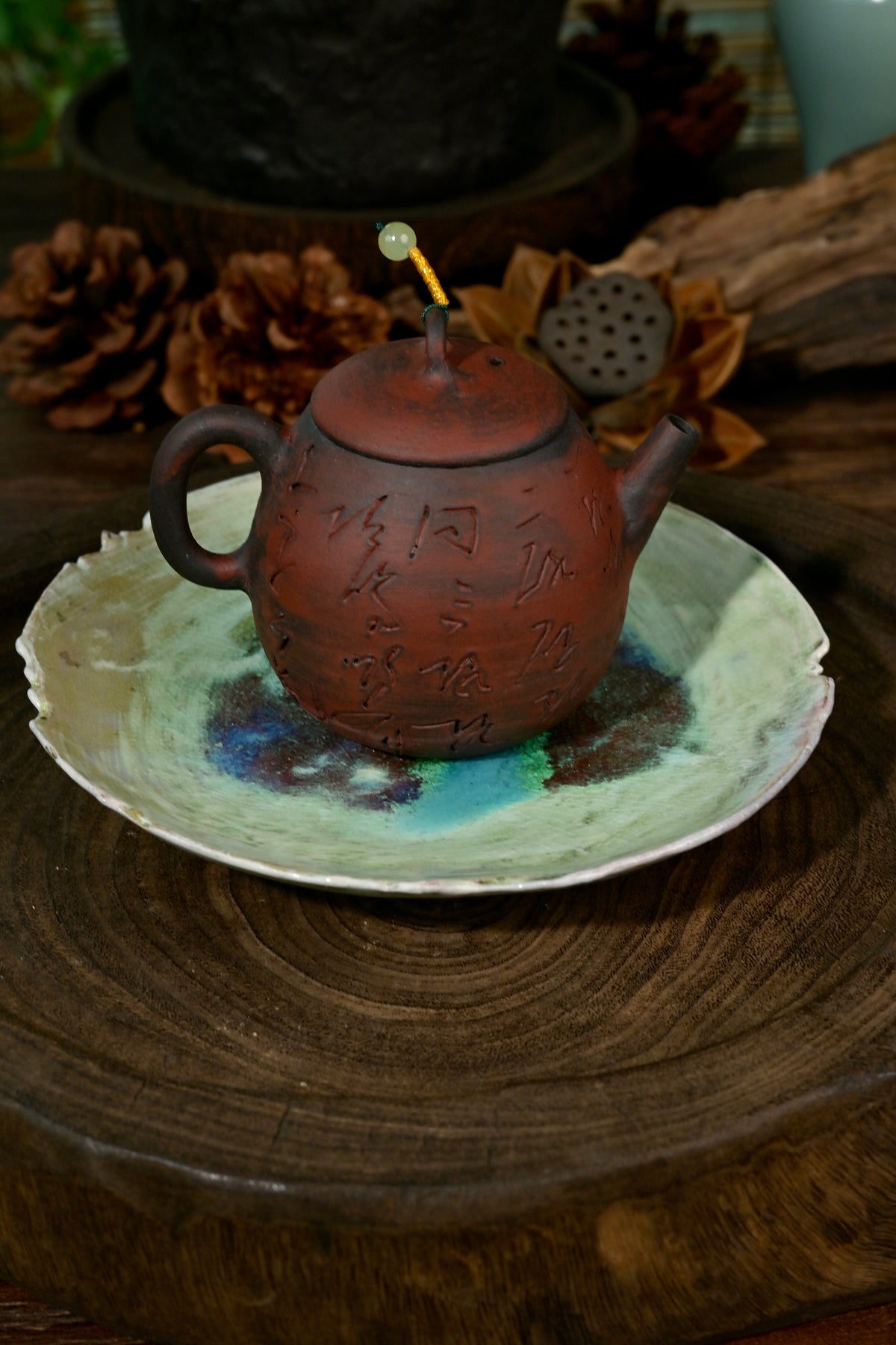 Artisanal soda-fired coaster plate displaying vibrant cosmic blue and brown flame marks