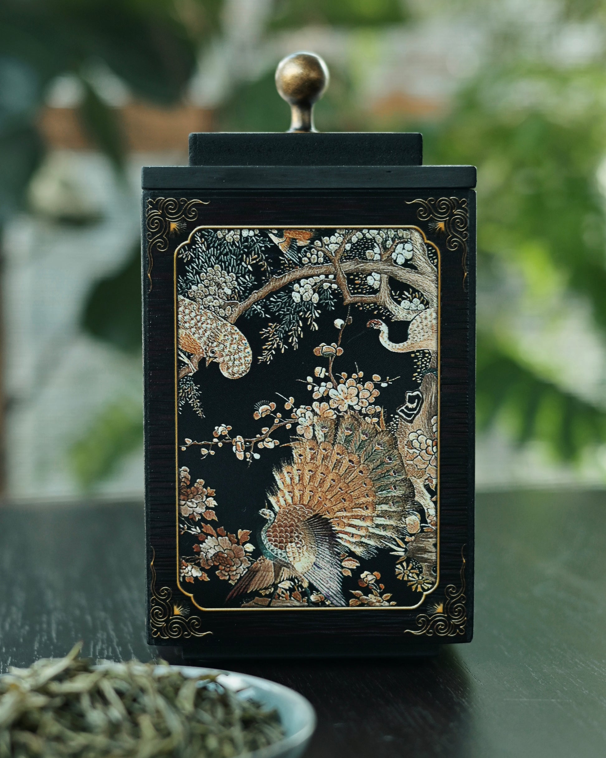 Anion-emitting bamboo charcoal tea canister with raised phoenix artwork, preserving tea freshness naturally