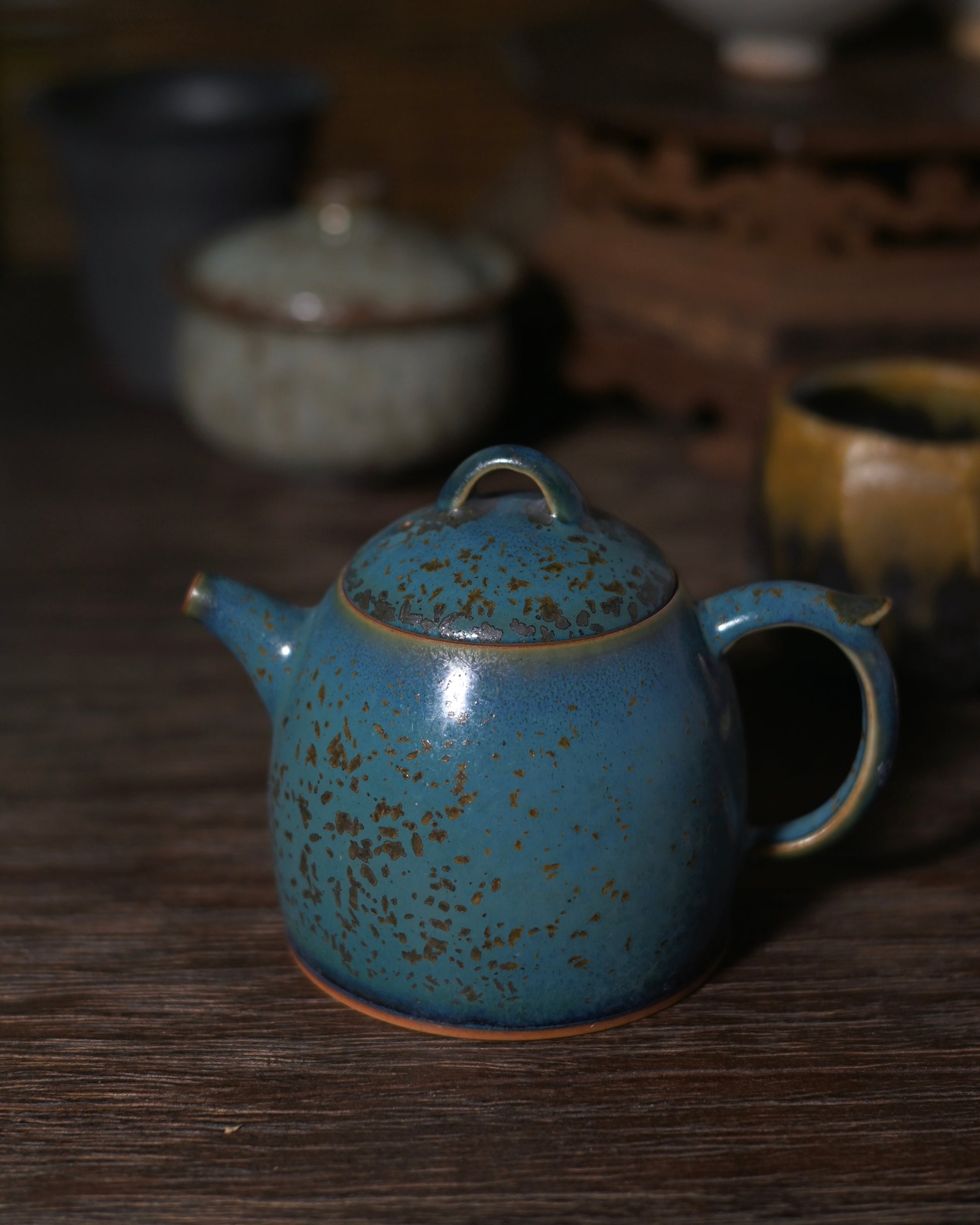 Pine-green kiln-transformed glaze with distinct blue undertones and spontaneous unrepeatable star-like patterns