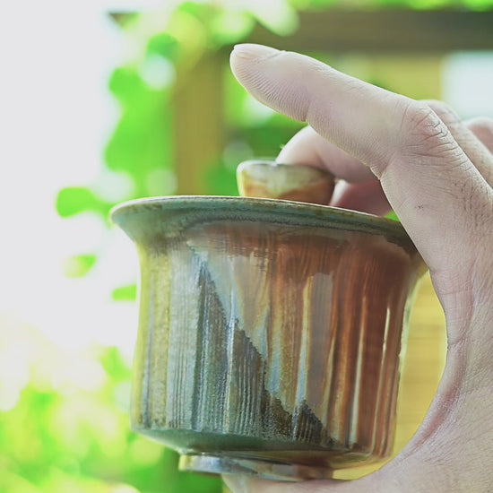 Handcrafted wood-fired natural ash glaze gaiwan perfect for oolong tea brewing.