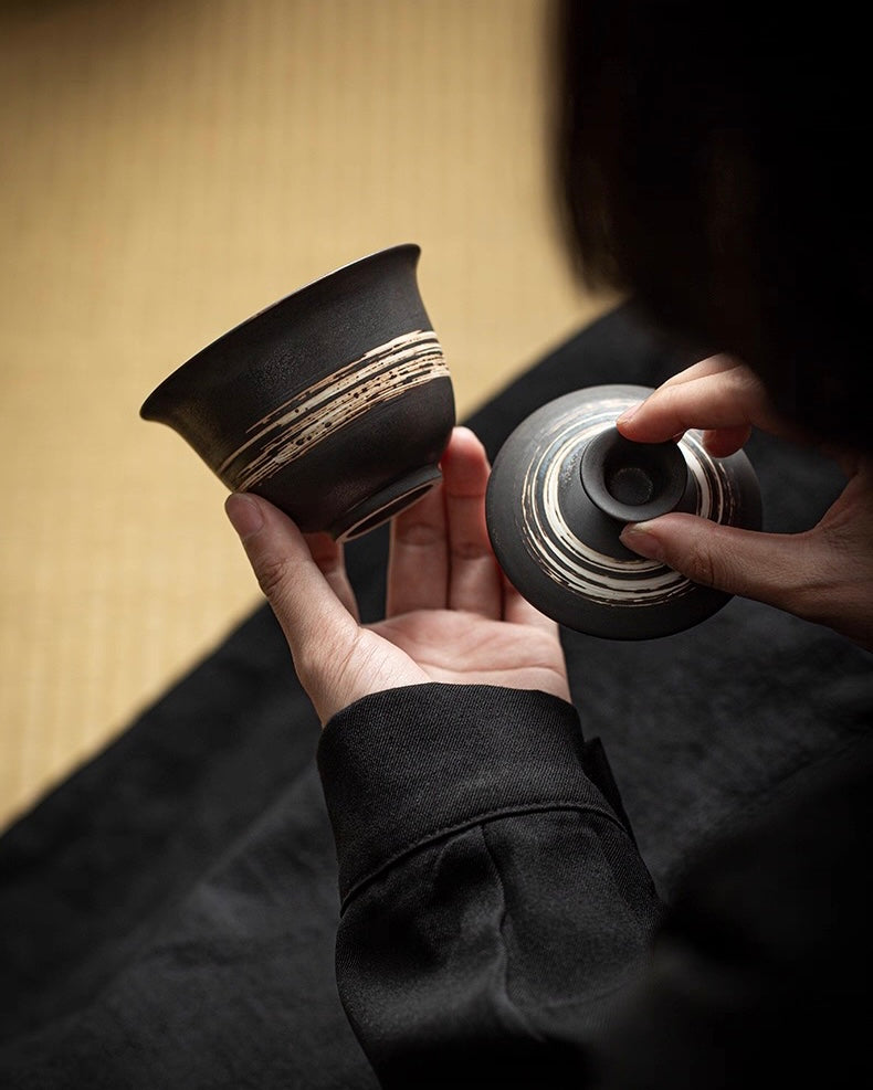 Earth tone tea ceremony set with rough-hewn edges, connecting tea practice to natural elements