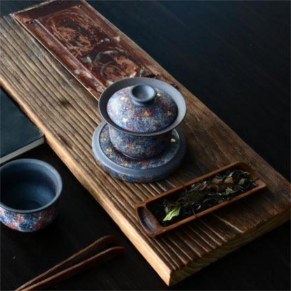 Luxury Yixing zisha gaiwan featuring gold mineral embellishments on antique purple clay, presented as an elite gift for tea ceremony enthusiasts.