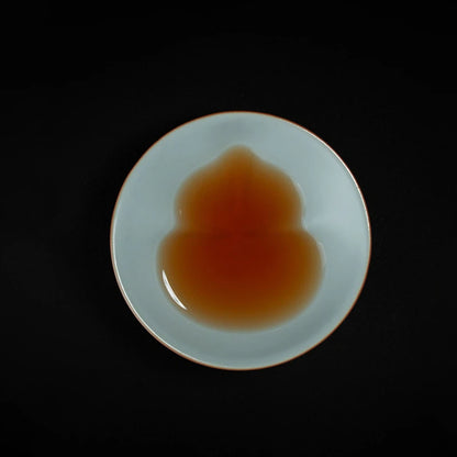Handmade Ru Kiln douli teacup featuring natural ice crackle glaze and a subtle hidden gourd form, inspired by classical Chinese tea aesthetics.