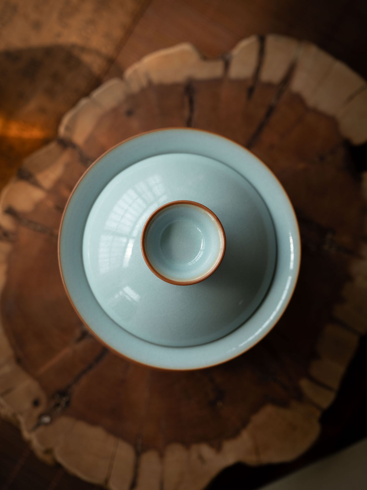 Authentic Song Dynasty style Ru porcelain gaiwan tea set arranged on a dark wooden Gongfu tea tray