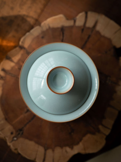 Authentic Song Dynasty style Ru porcelain gaiwan tea set arranged on a dark wooden Gongfu tea tray