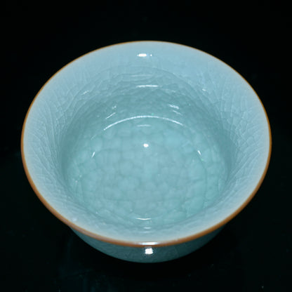 Handcrafted celadon teacup featuring agate-enhanced glaze and classic crackle aesthetics