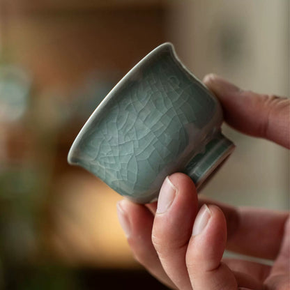 Detailed view of the main teapot or gaiwan featuring relief patterns and a smooth porcelain lid.