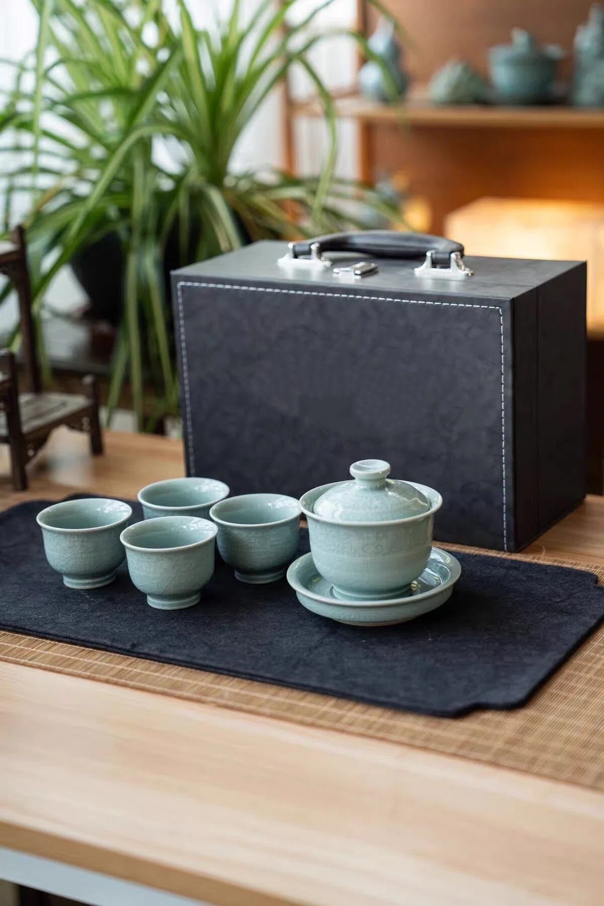 Detailed view of the main teapot or gaiwan featuring relief patterns and a smooth porcelain lid.