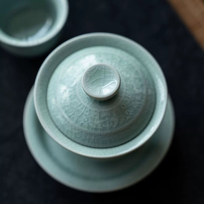 Macro view showing the soft powder-celadon glaze finish and intricate crackle pattern.