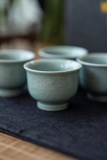 Macro view showing the soft powder-celadon glaze finish and intricate crackle pattern.